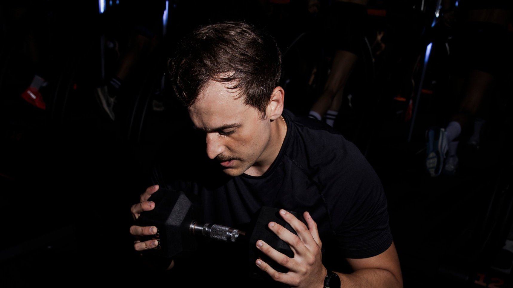Strength training with a dumbbell at the bench in a Burn Baby class
